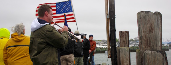 Matt Swain played Taps at Greenport's Memorial Day service at the Railroad Dock Monday morning.