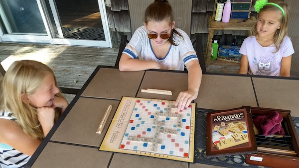 From left: Jennifer Luke, her friend Jane Rocco and little sister Violetta Luke play Scrabble over their summer vacation. | Jennifer Luke photo
